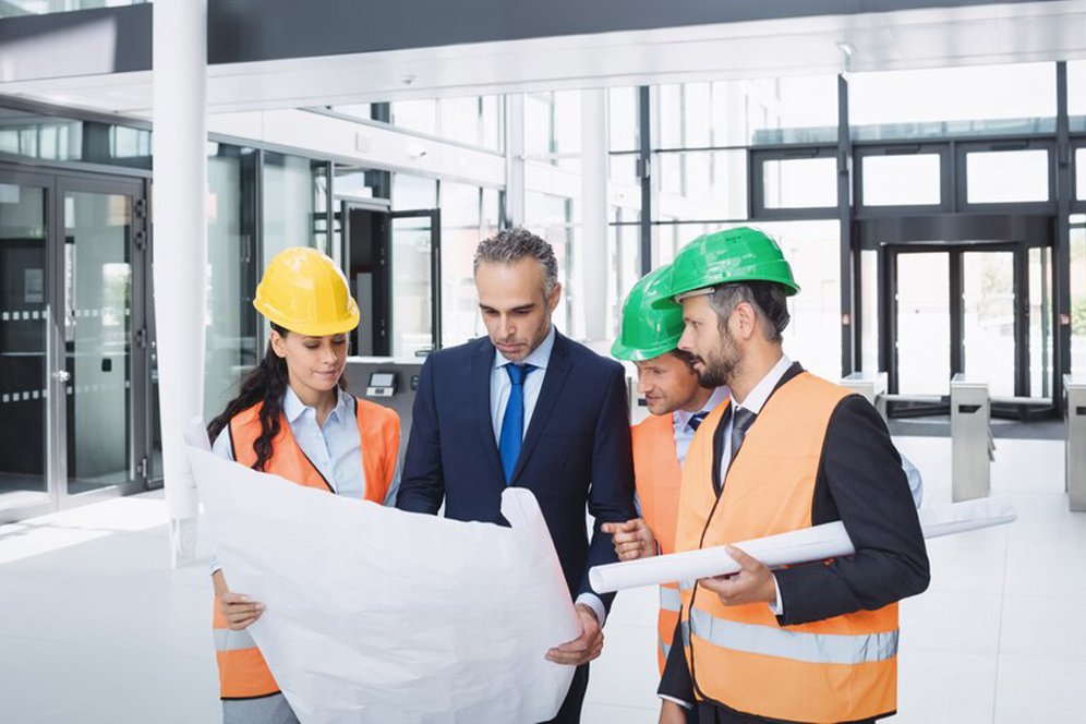 businessman-discussing-blueprint-with-architects_107420-74345 VISR Management